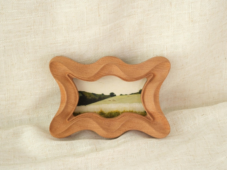 Handcrafted wooden picture frame, with a wavy, irregularly carved dog bone frame, suitable for wall or table decoration.