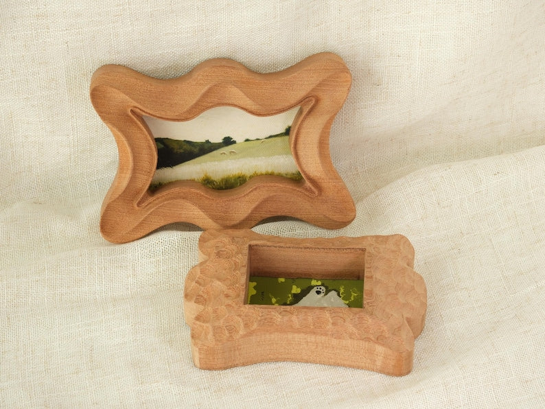 Handcrafted wooden picture frame, with a wavy, irregularly carved dog bone frame, suitable for wall or table decoration.