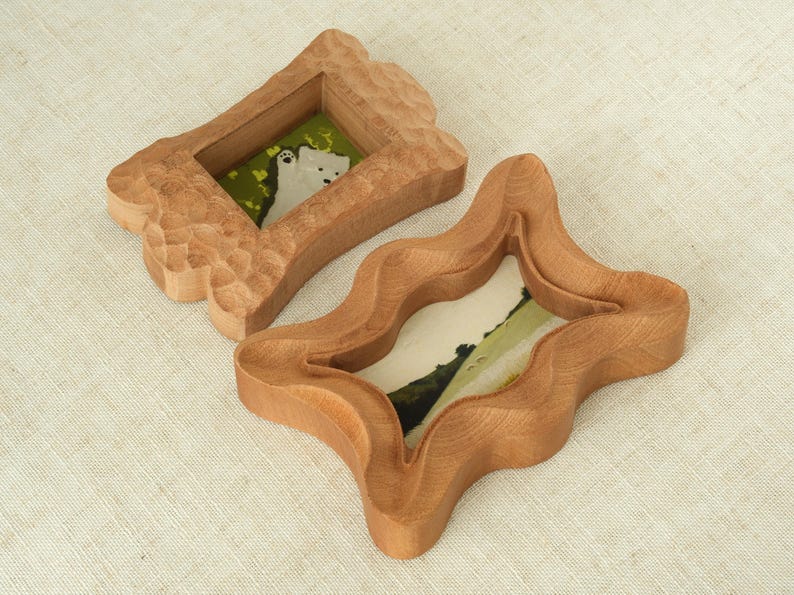Handcrafted wooden picture frame, with a wavy, irregularly carved dog bone frame, suitable for wall or table decoration.